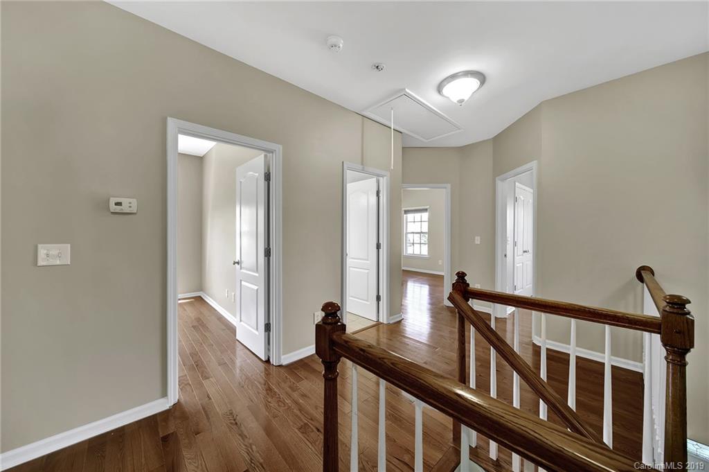 866 Treasure Court Fort Mill, SC 29708 - Photo 7 of 38 a view of a hallway view with wooden floor and staircase