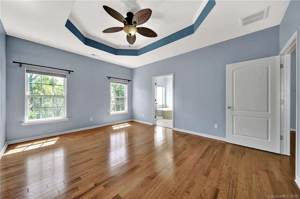 866 Treasure Court Fort Mill, SC 29708 - Photo 8 of 38 a view of an empty room with wooden floor and a window