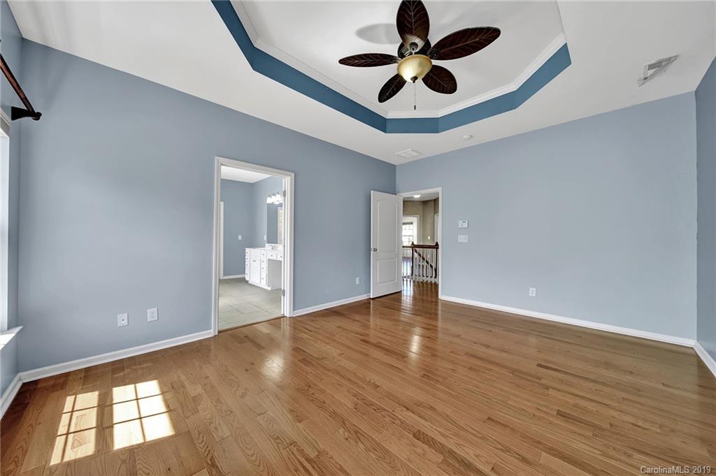866 Treasure Court Fort Mill, SC 29708 - Photo 9 of 38 a view of an empty room with window and wooden floor