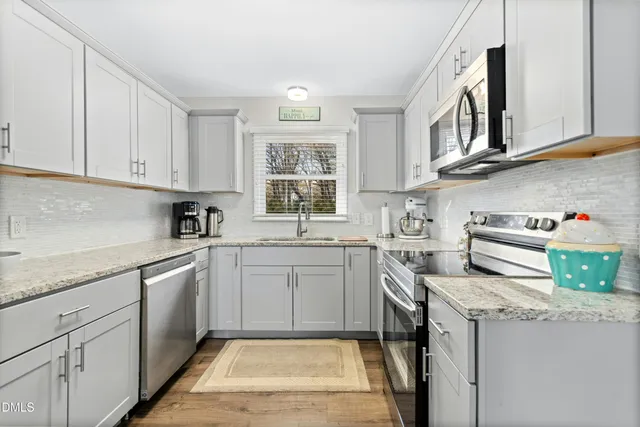 a view of a dining room with furniture wooden floor and chandelier