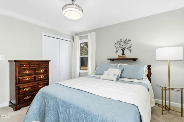 a bedroom with a bed window and a desk
