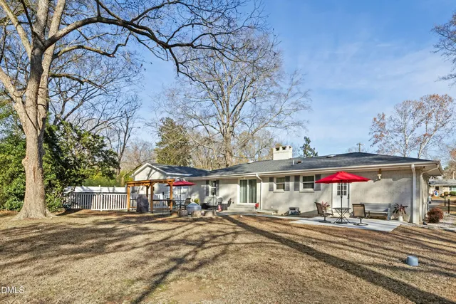 a view of a backyard with wooden fence