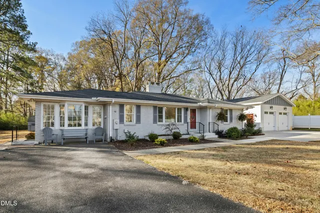 a view of a house with a yard covered in snow