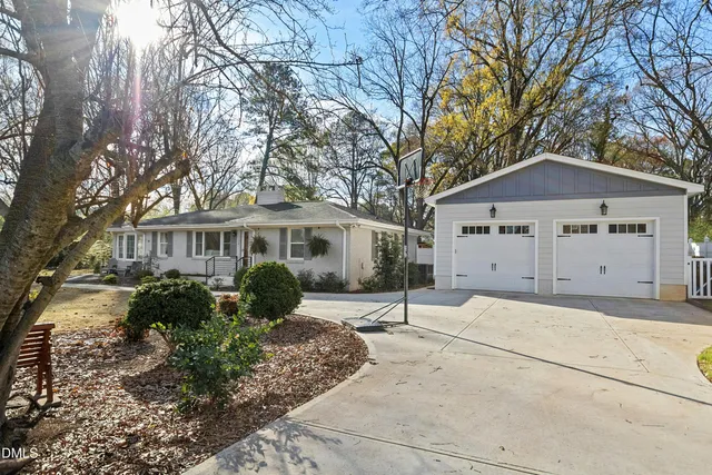 a front view of a house with a garden