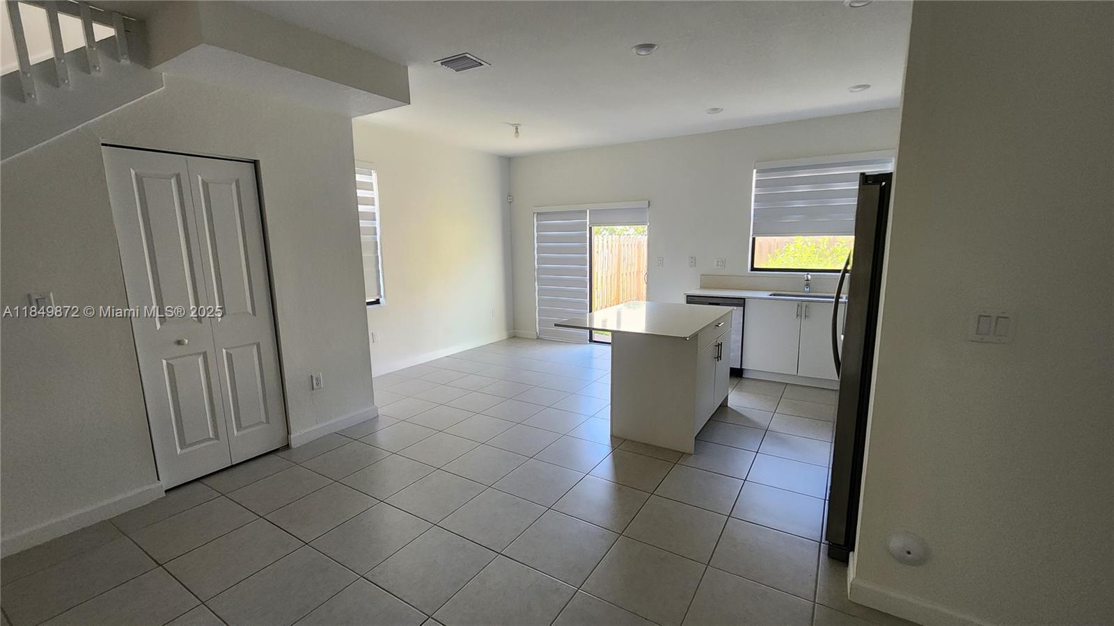 12897 Southwest 234th Street Homestead, FL 33032 - Photo 16 of 24 a view of a kitchen with an empty space and a window