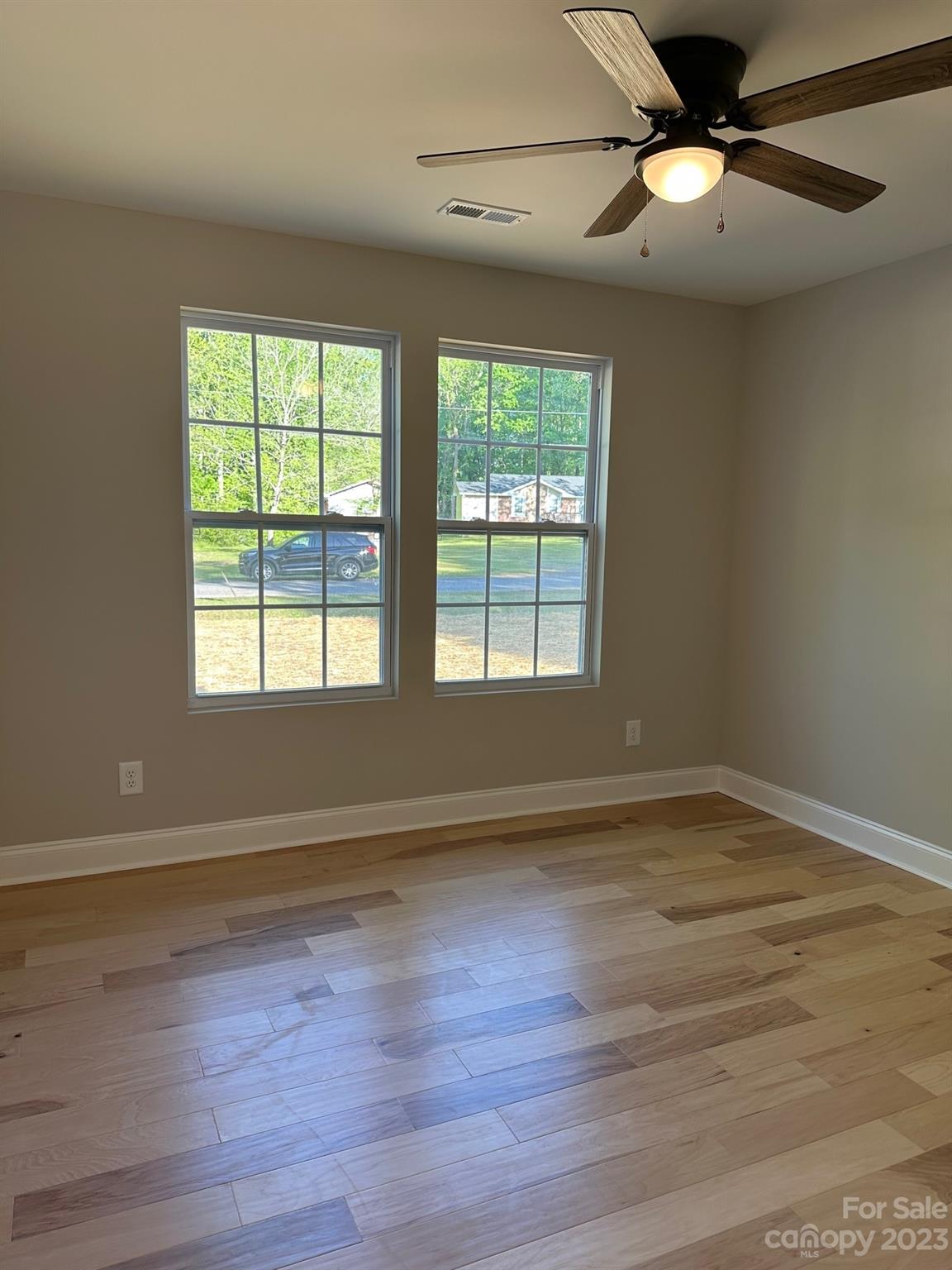 1091 Tryon Street Lancaster, SC 29720 - Photo 16 of 30 a view of an empty room with wooden floor and a window