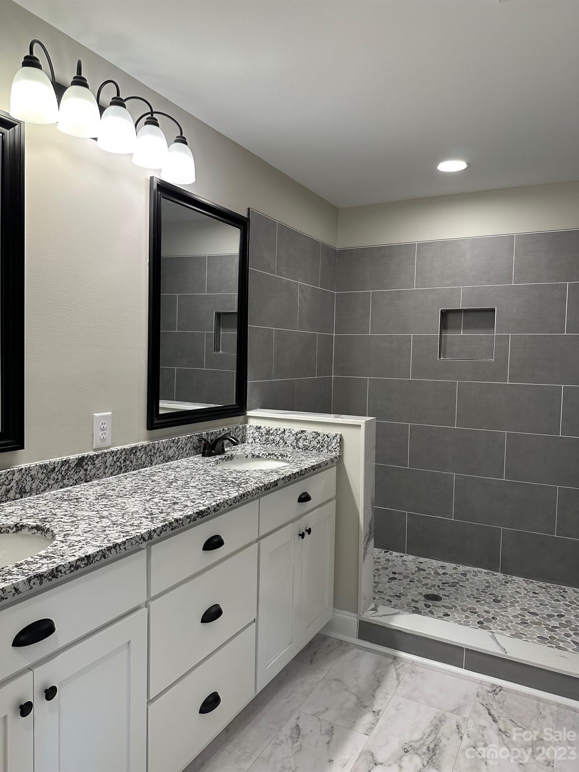 1091 Tryon Street Lancaster, SC 29720 - Photo 27 of 30 a bathroom with a granite countertop sink and a mirror