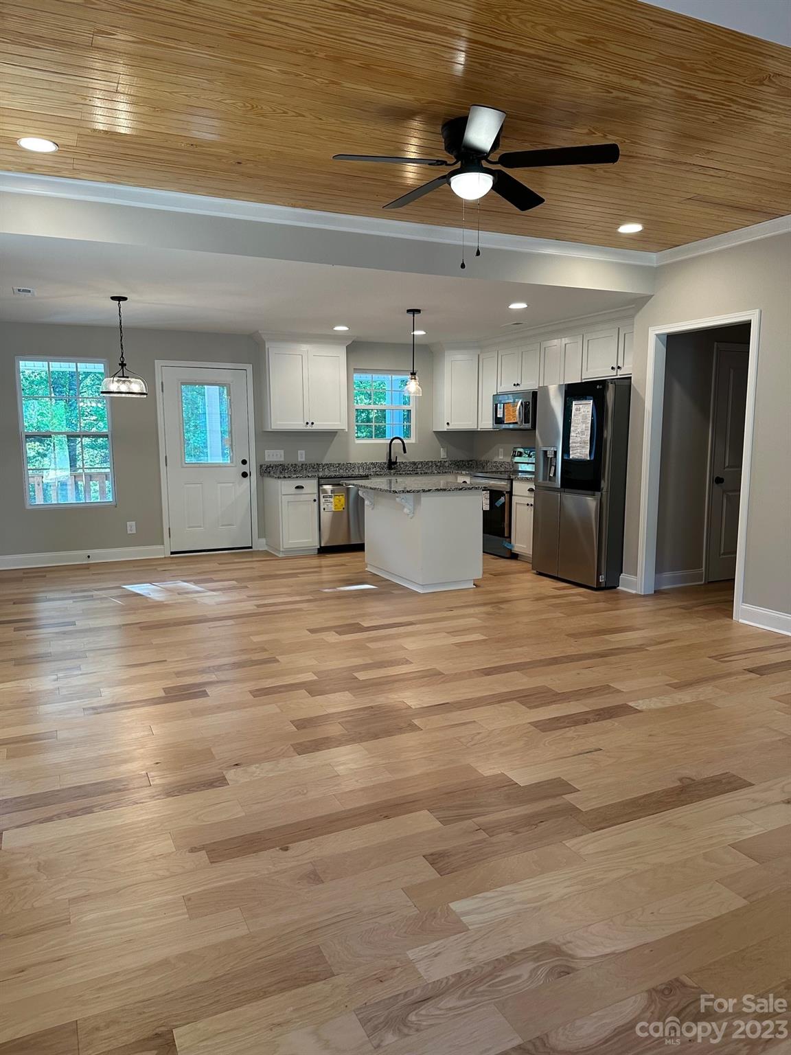 1091 Tryon Street Lancaster, SC 29720 - Photo 10 of 30 a kitchen with stainless steel appliances kitchen island granite countertop a refrigerator a stove and a sink with dishwasher