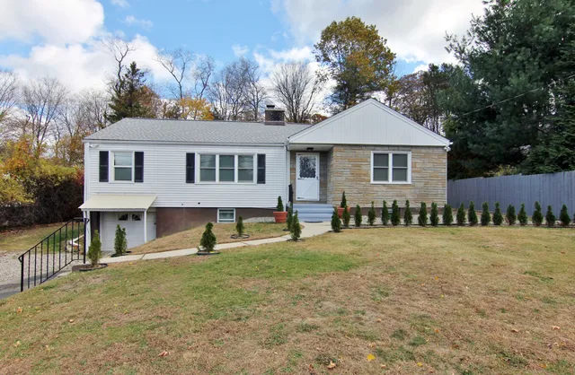 a front view of a house with a yard