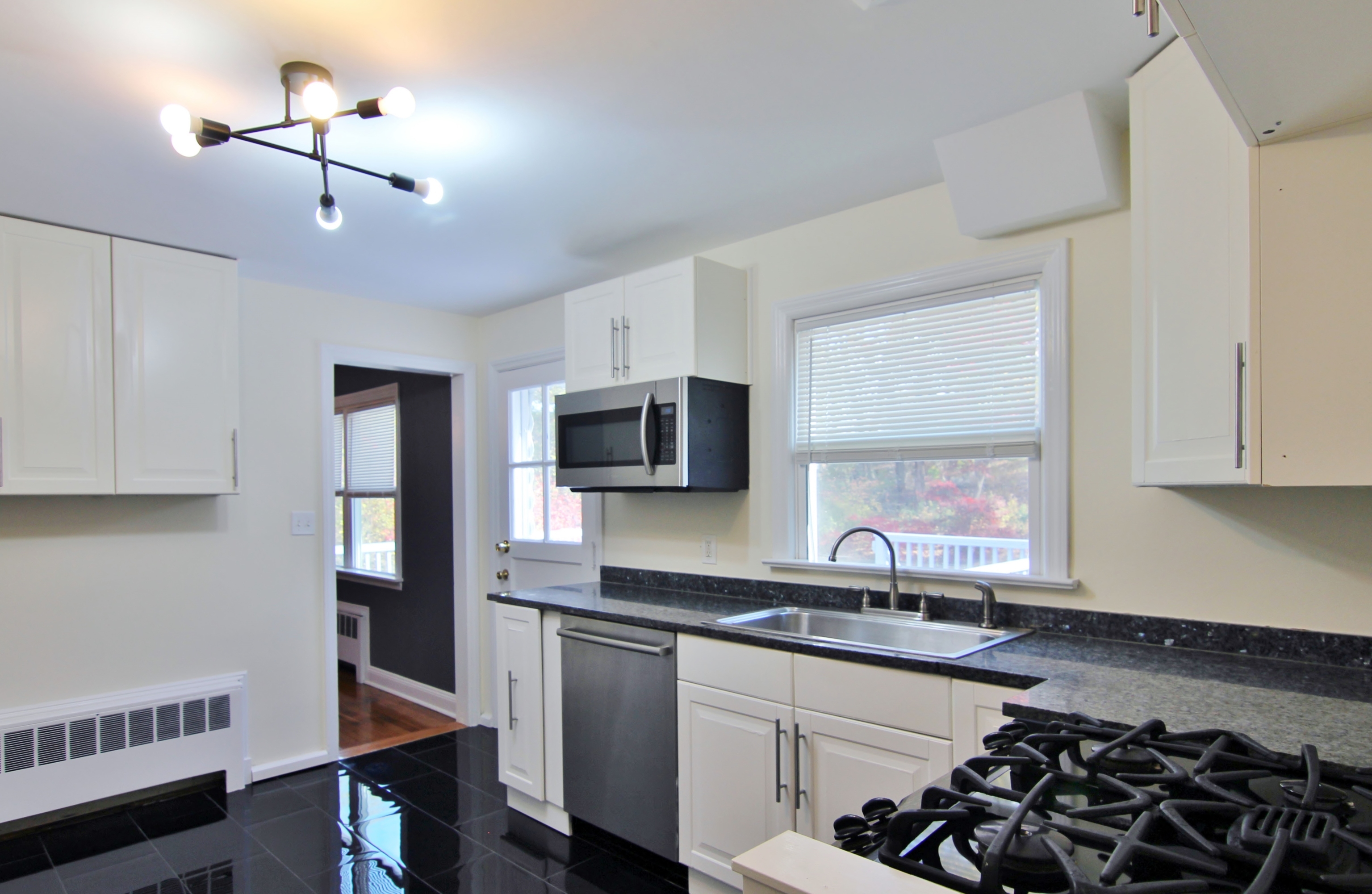 663 High Ridge Road Stamford, CT 06905 - Photo 12 of 27 a kitchen with a sink stove and microwave