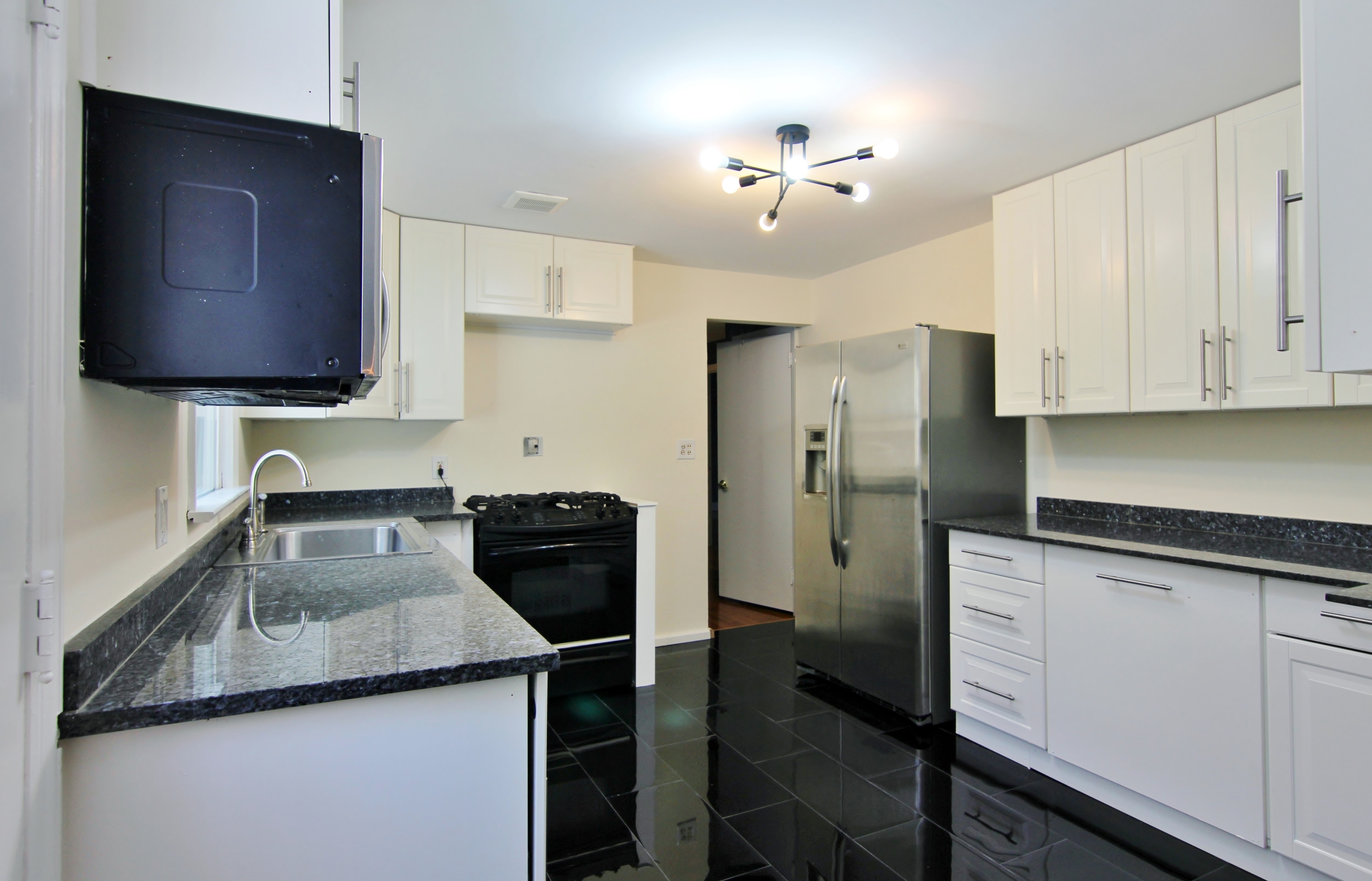 663 High Ridge Road Stamford, CT 06905 - Photo 14 of 27 a kitchen with a refrigerator sink and stove