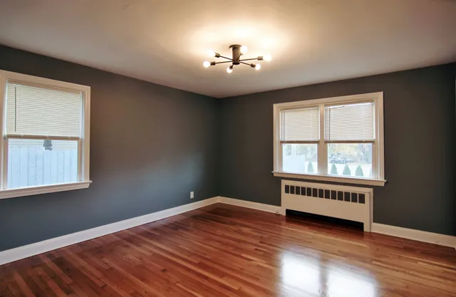 wooden floor in an empty room with a window