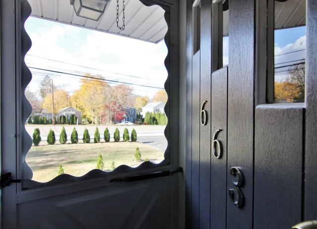 a front view of a house with a yard covered in snow