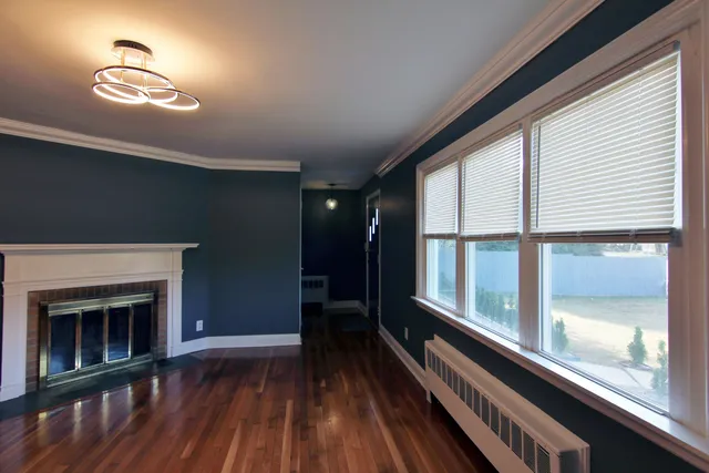 a view of a room with wooden floor and a window