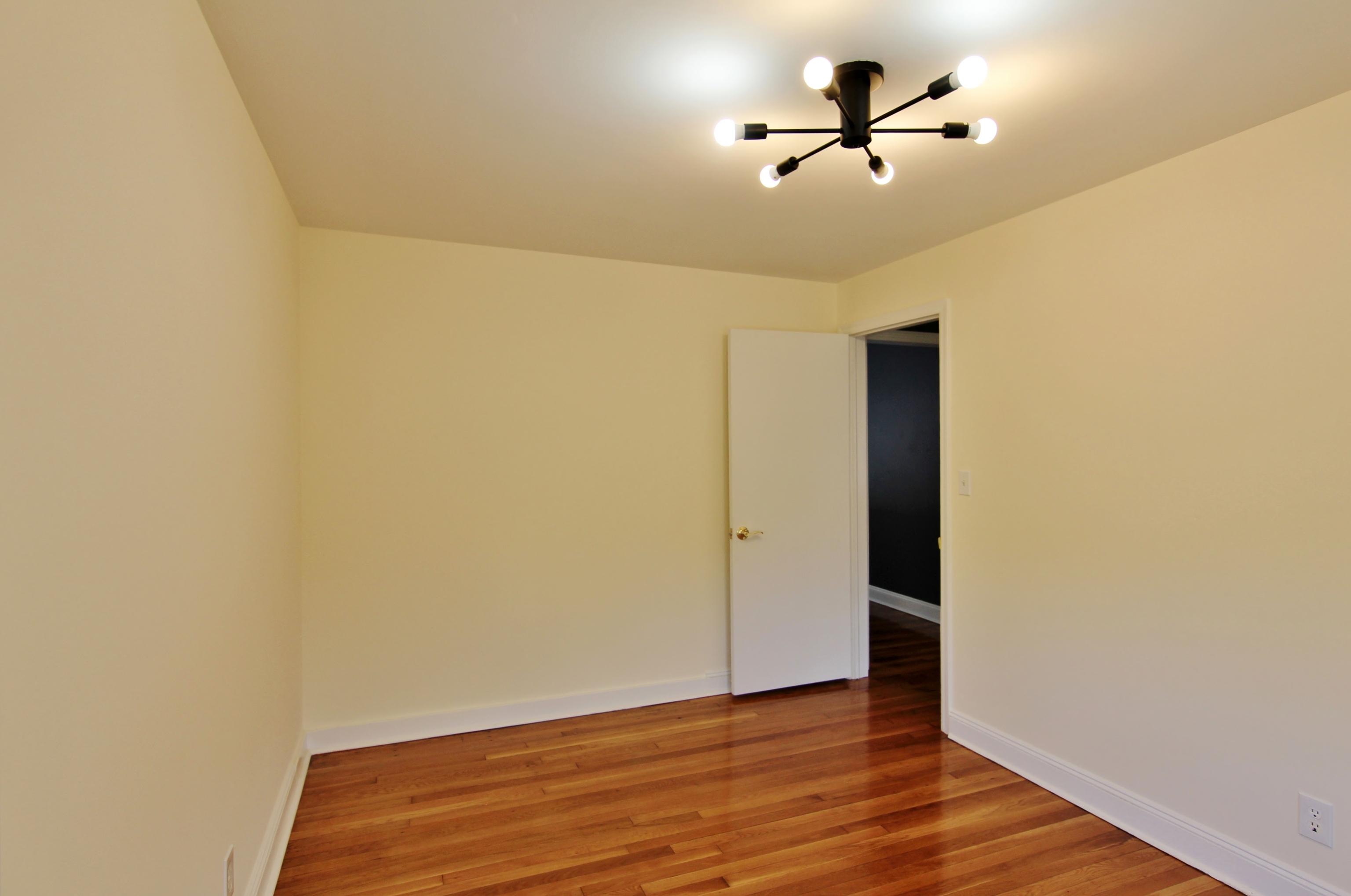 663 High Ridge Road Stamford, CT 06905 - Photo 6 of 27 a view of a room with wooden floor and a ceiling fan