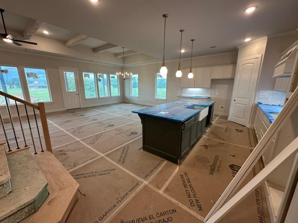 585 Brown Road Leonard, TX 75452 - Photo 9 of 29 Spacious open-concept living area featuring a large kitchen island with an integrated farmhouse sink, pendant lighting, and recessed ceiling lights