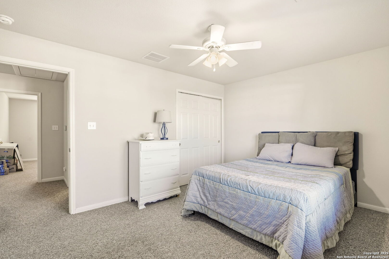 133 Falling Sun Cibolo, TX 78108 - Photo 18 of 28 a bedroom with a bed and a chandelier