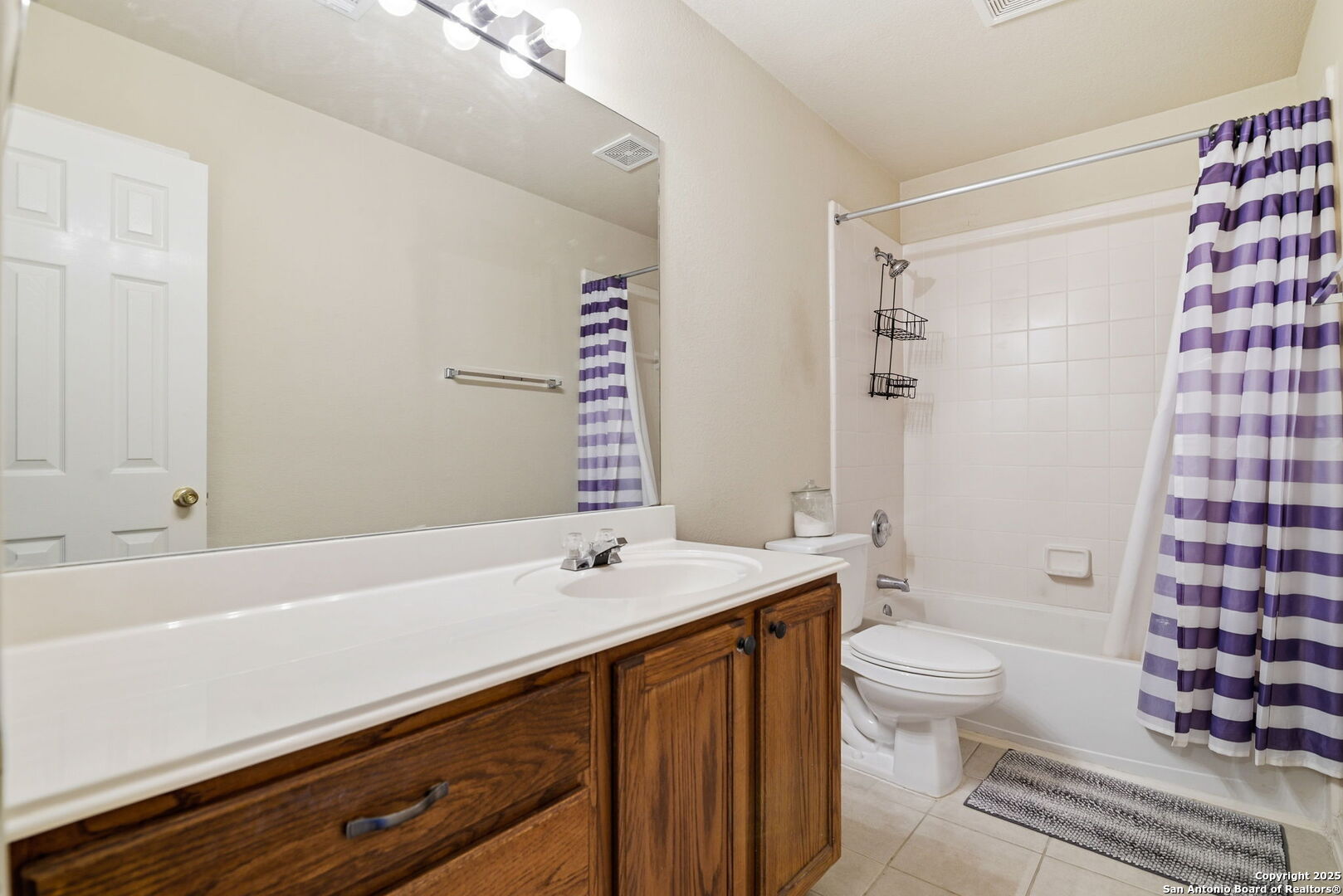 133 Falling Sun Cibolo, TX 78108 - Photo 18 of 27 a bathroom with a sink a toilet a shower and a mirror