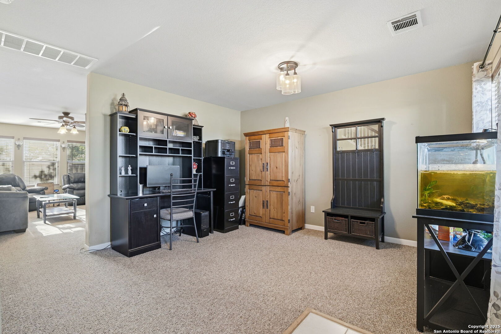 133 Falling Sun Cibolo, TX 78108 - Photo 6 of 28 a view of a livingroom with furniture and a flat screen tv