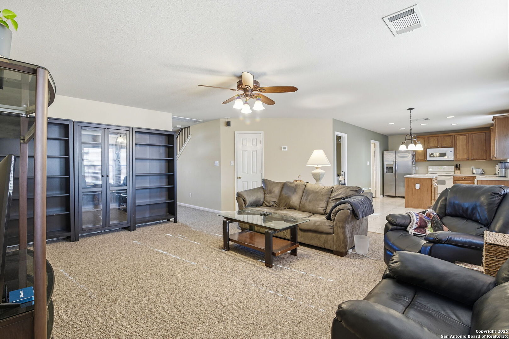 133 Falling Sun Cibolo, TX 78108 - Photo 9 of 28 a living room with furniture a ceiling fan and a rug