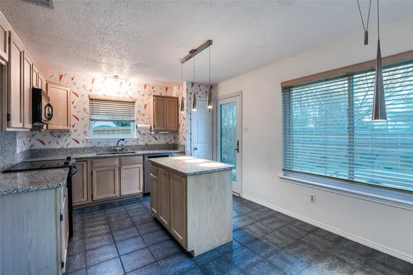 a kitchen with a sink stove and cabinets