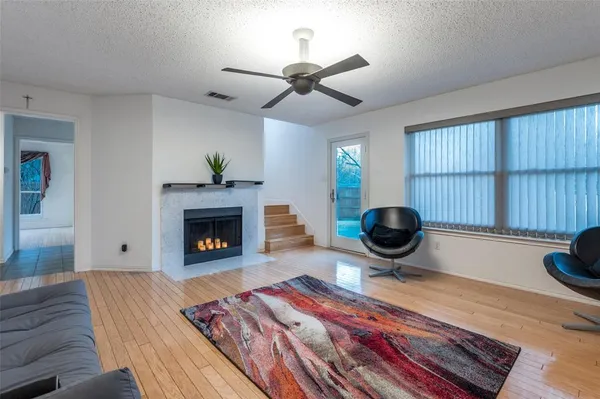 a living room with a fireplace furniture a rug and a fireplace