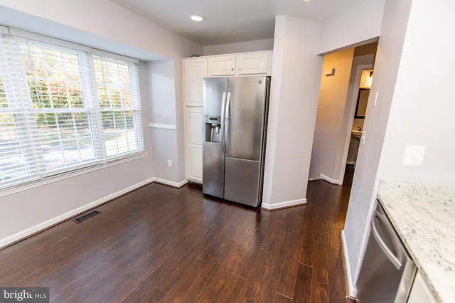 a view of a kitchen with wooden floor and staircase