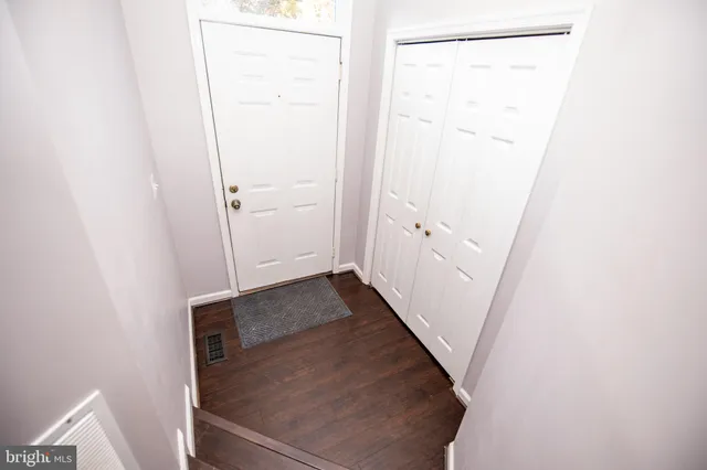 a view of walk in closet with wooden floor