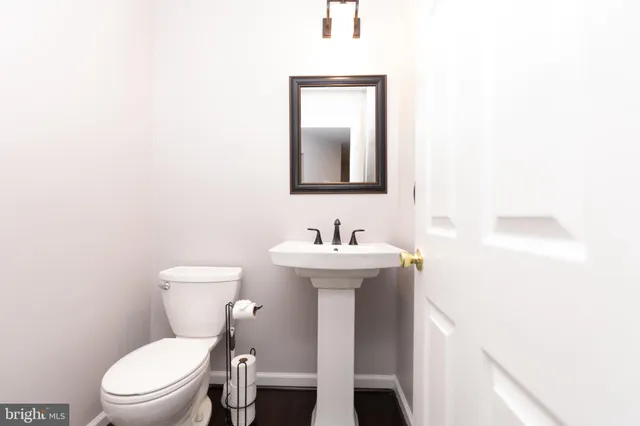 a bathroom with a sink a toilet and mirror