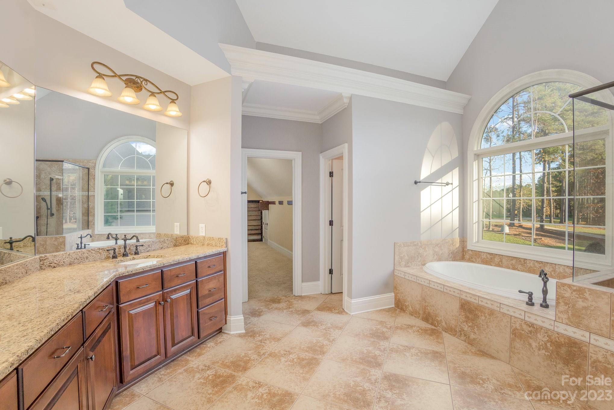 142 Blue Ridge Trail Mooresville, NC 28117 - Photo 18 of 32 a spacious bathroom with a tub sink shower and mirror