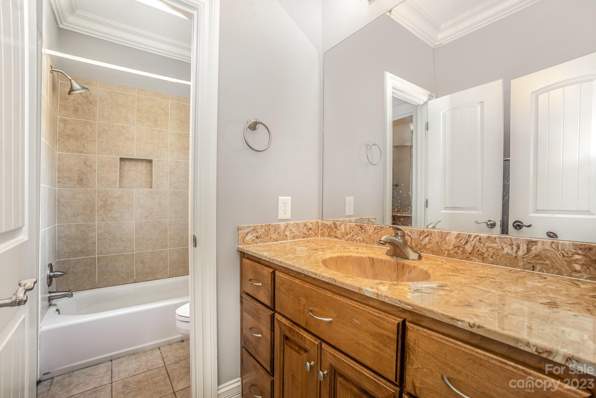 142 Blue Ridge Trail Mooresville, NC 28117 - Photo 20 of 32 a bathroom with a granite countertop sink tub shower and a mirror