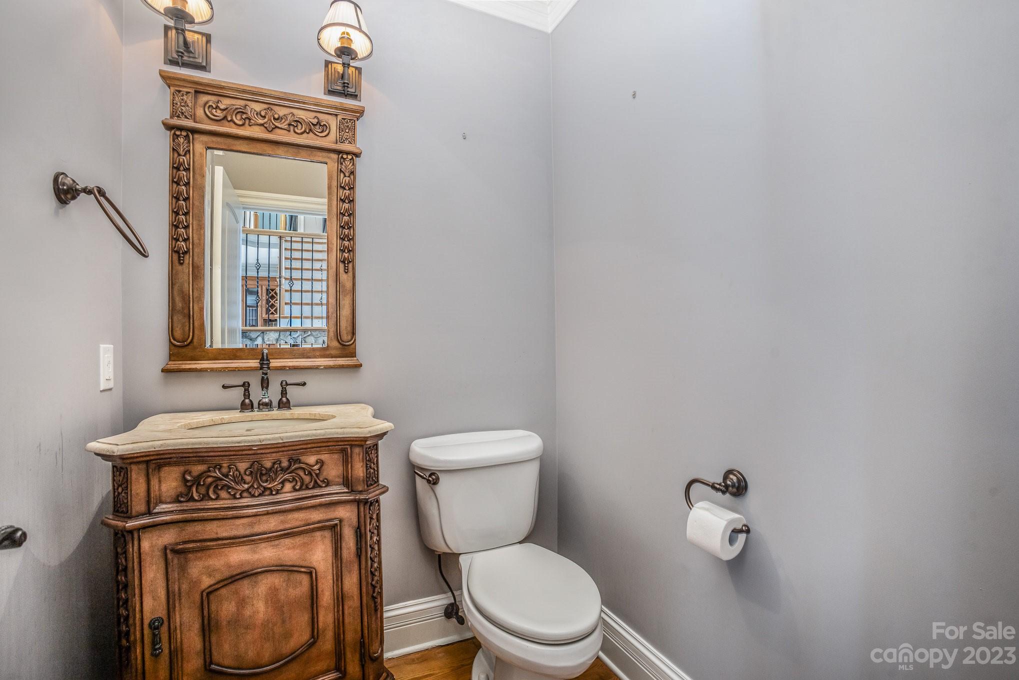 142 Blue Ridge Trail Mooresville, NC 28117 - Photo 25 of 32 a bathroom with a toilet a sink and a mirror