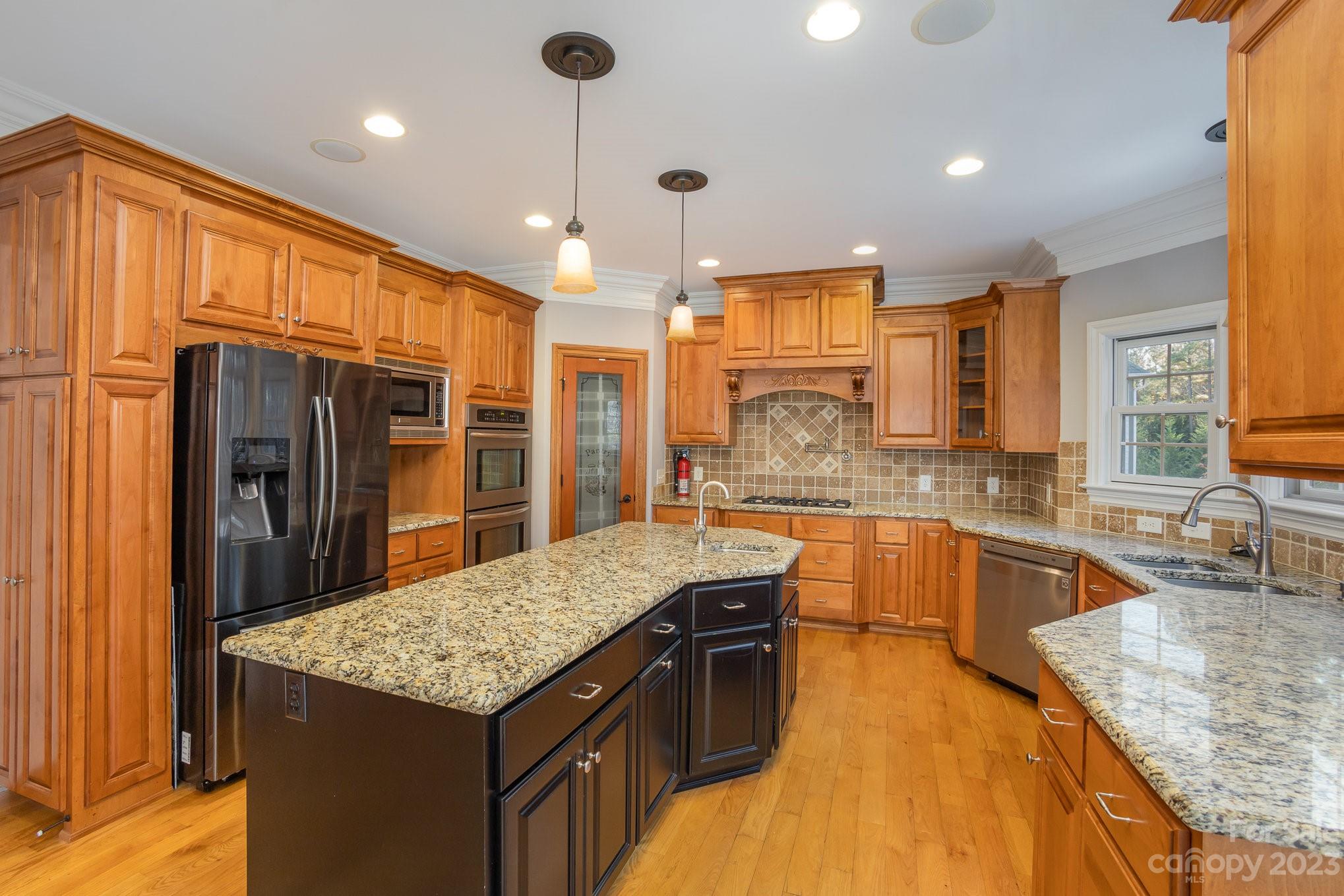 142 Blue Ridge Trail Mooresville, NC 28117 - Photo 8 of 32 a kitchen with stainless steel appliances granite countertop a sink stove and refrigerator