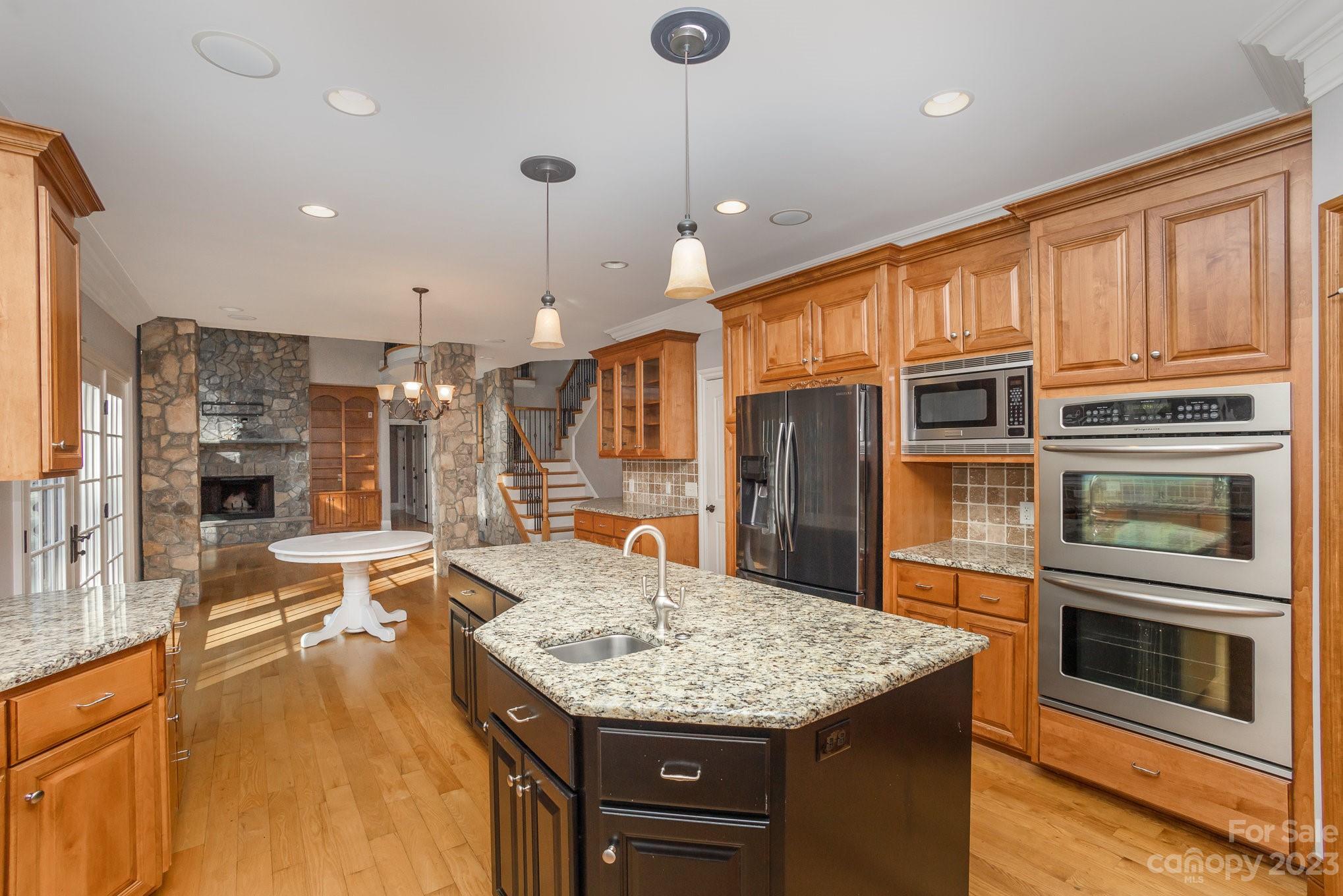 142 Blue Ridge Trail Mooresville, NC 28117 - Photo 9 of 32 a kitchen with stainless steel appliances granite countertop a stove and cabinets