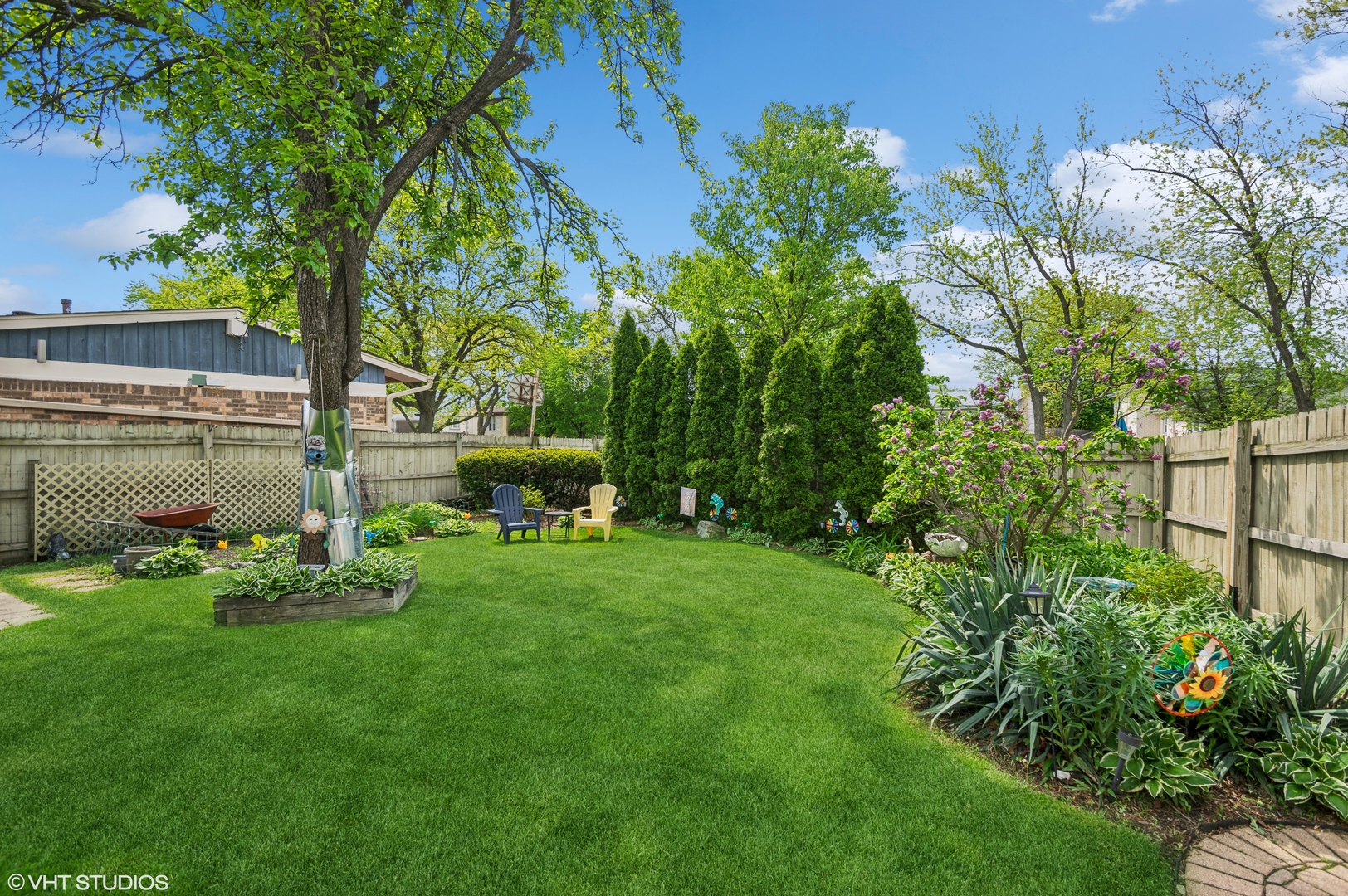 7962 Beckwith Road Morton Grove, IL 60053 - Photo 25 of 30 a garden with a bench in front of the house