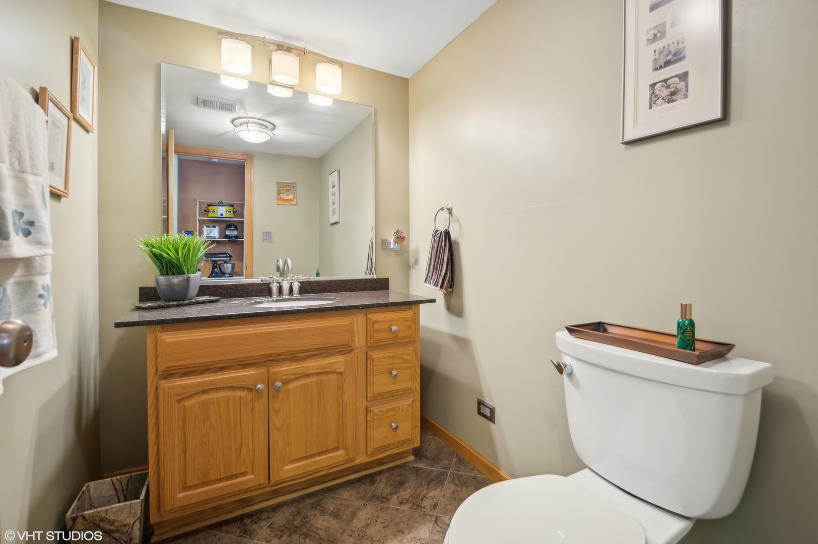 7962 Beckwith Road Morton Grove, IL 60053 - Photo 4 of 30 a bathroom with a granite countertop toilet sink and mirror