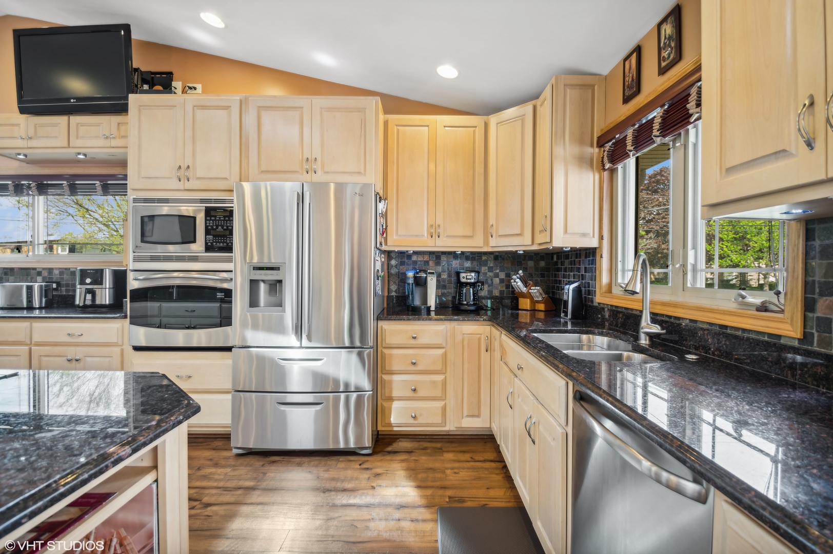 7962 Beckwith Road Morton Grove, IL 60053 - Photo 6 of 30 a kitchen with stainless steel appliances granite countertop a stove a sink and a microwave