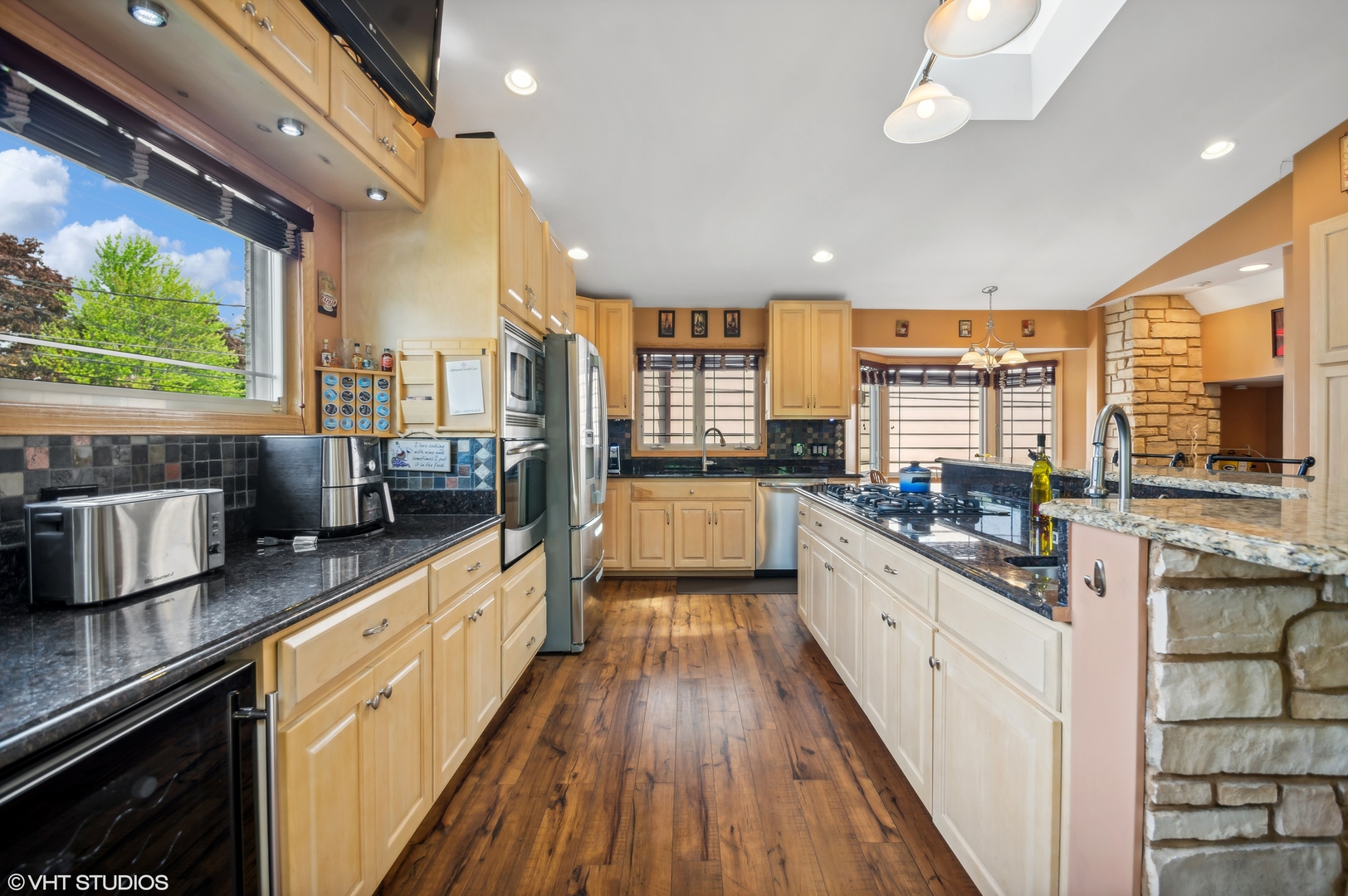 7962 Beckwith Road Morton Grove, IL 60053 - Photo 7 of 30 a large kitchen with stainless steel appliances granite countertop a lot of counter space and wooden floors
