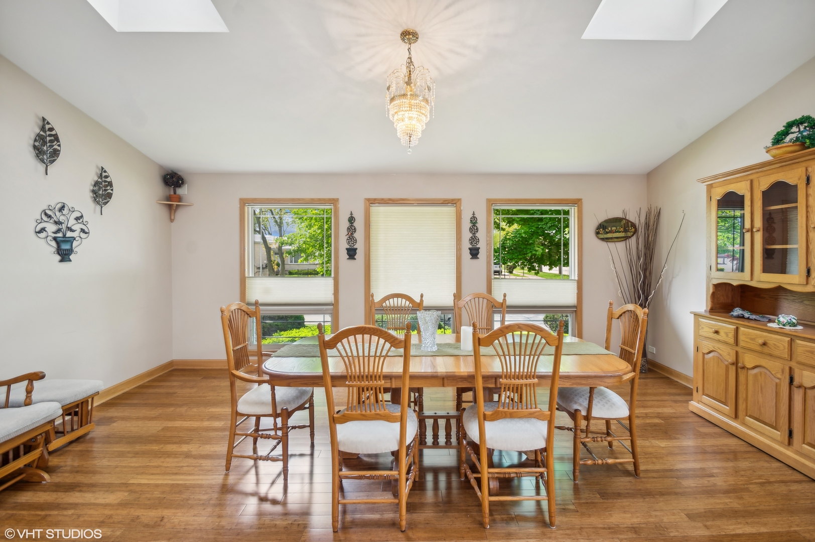 7962 Beckwith Road Morton Grove, IL 60053 - Photo 10 of 30 a view of a dining room with furniture a chandelier and wooden floor