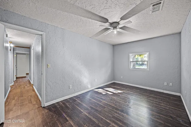 a view of an empty room and wooden floor