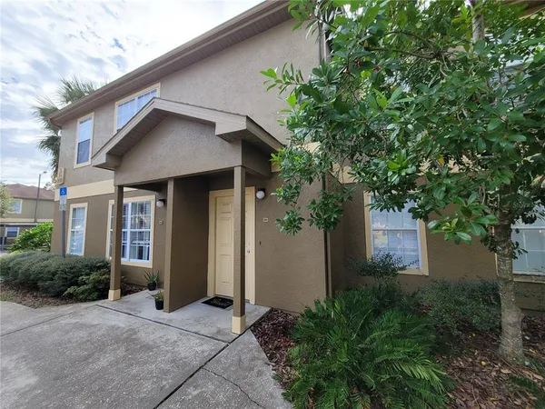 a front view of a house with yard and green space