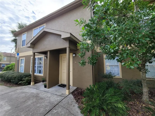 a front view of a house with yard and green space