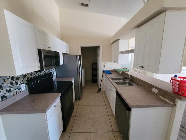 a kitchen with a sink stove and refrigerator