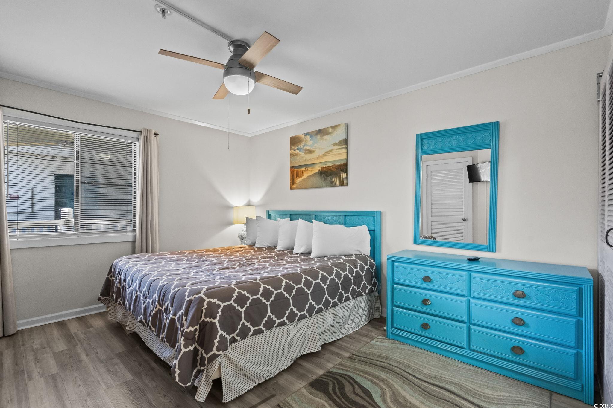 415 Ocean Creek Drive, Unit 2346 Myrtle Beach, SC 29572 - Photo 17 of 40 Bedroom with crown molding, wood finished floors, and a ceiling fan