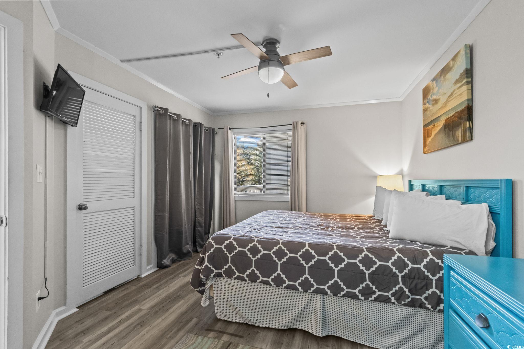 415 Ocean Creek Drive, Unit 2346 Myrtle Beach, SC 29572 - Photo 18 of 40 Bedroom with crown molding, wood finished floors, a closet, and a ceiling fan