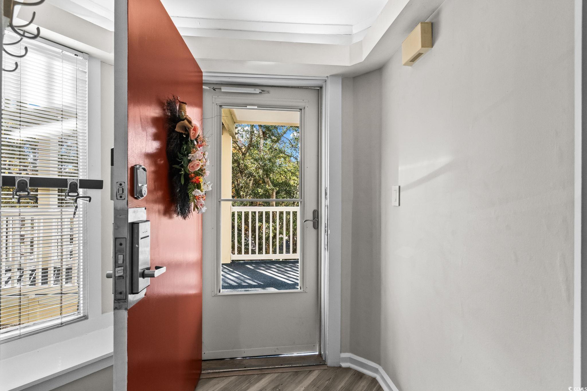 415 Ocean Creek Drive, Unit 2346 Myrtle Beach, SC 29572 - Photo 2 of 40 Doorway to outside with wood finished floors and baseboards