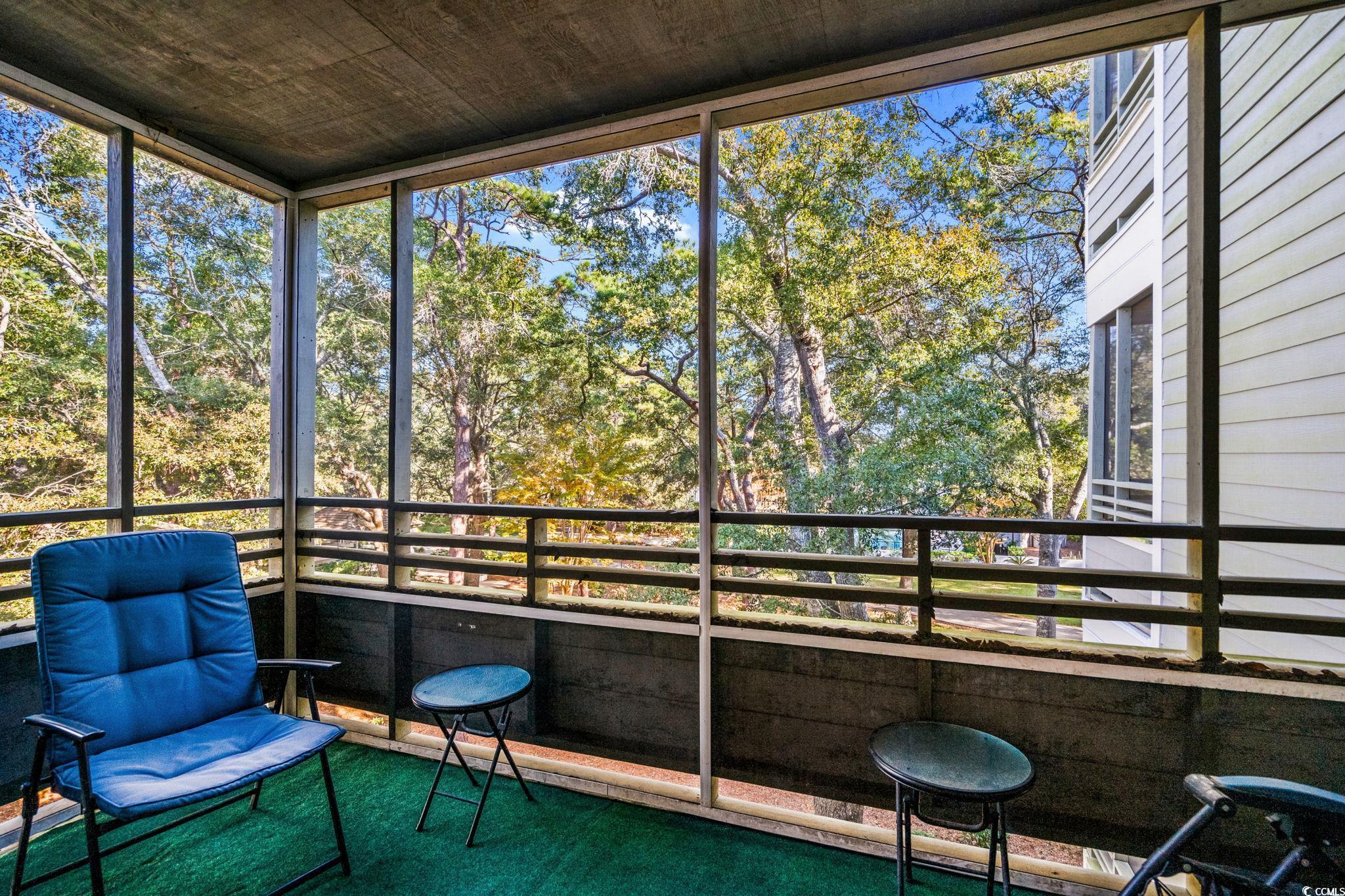 415 Ocean Creek Drive, Unit 2346 Myrtle Beach, SC 29572 - Photo 24 of 40 Screen Porch with view of wooded area