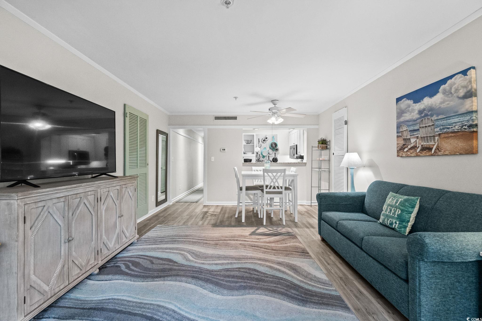 415 Ocean Creek Drive, Unit 2346 Myrtle Beach, SC 29572 - Photo 3 of 40 Living room with wood finished floors, ornamental molding, and ceiling fan