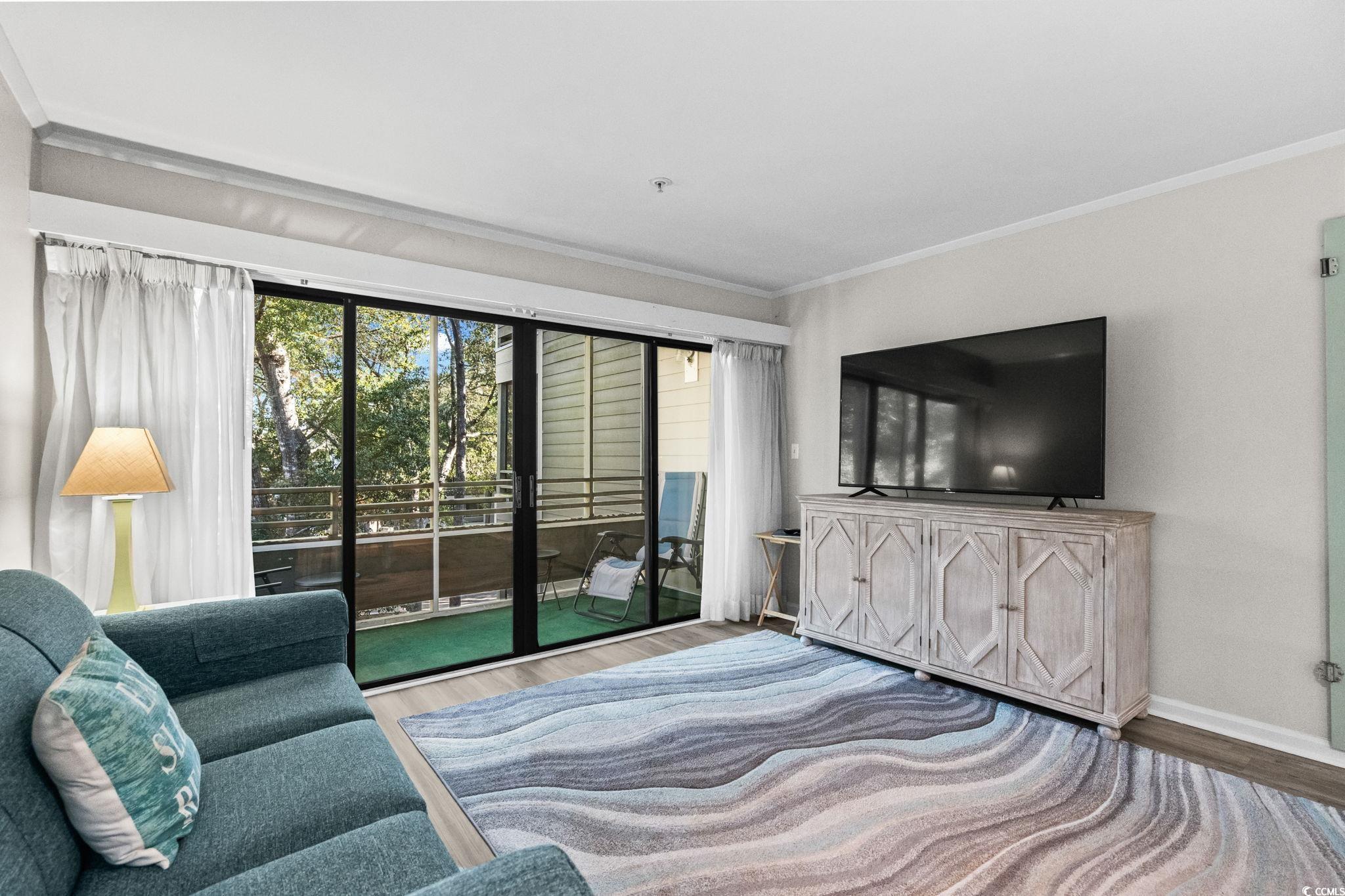 415 Ocean Creek Drive, Unit 2346 Myrtle Beach, SC 29572 - Photo 5 of 40 Living area with crown molding and wood finished floors