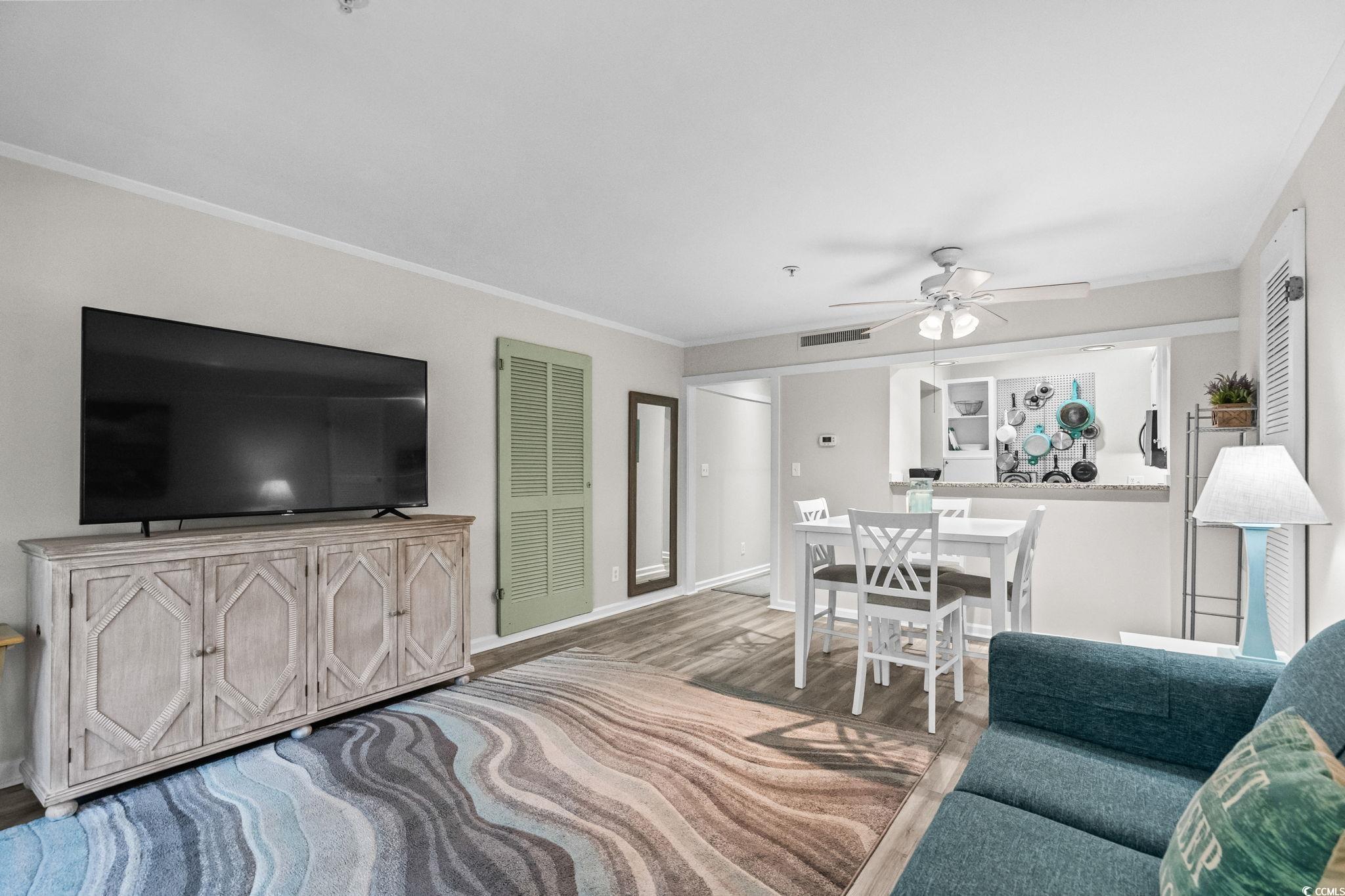 415 Ocean Creek Drive, Unit 2346 Myrtle Beach, SC 29572 - Photo 6 of 40 Living room with ornamental molding, wood finished floors, and ceiling fan